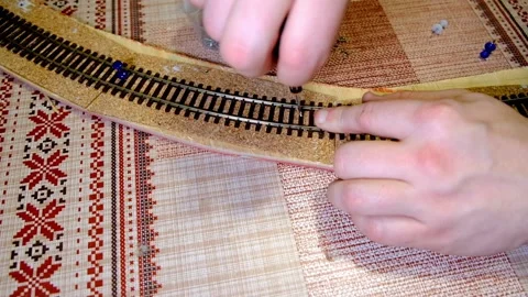 A man makes a model of a railroad Stock Footage 154678533