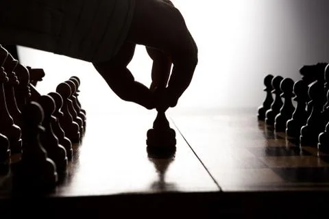 Man makes a move chess figure Stock Photos