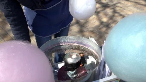 The man makes multicolored sugar wool Stock Footage 95308129