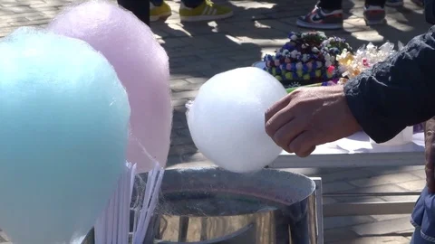 The man makes multicolored sugar wool Stock Footage 114436359