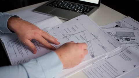 A man makes notes on drawings Stock Footage 142606912