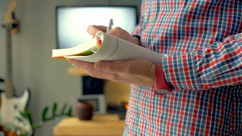 The man makes notes in a notebook and thinks about something. Stock Footage 129984141