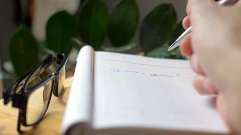 The man makes notes in a notebook and thinks about something. Stock Footage 129986640