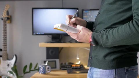 The man makes notes in a notebook and thinks about something. Stock Footage 129991754