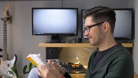 The man makes notes in a notebook and thinks about something. Stock Footage 129994138