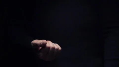 A man makes an obscene gesture showing the middle finger, close-up on a black Stock-Footage 120064679