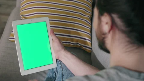 Man Makes Online Call Using Tablet Computer, Green Screen Stock Footage 133373529