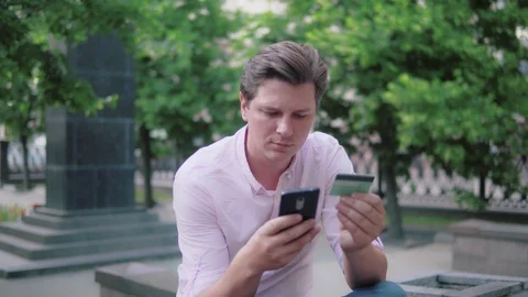 A man makes an online purchase using a phone. Stock Footage 90600628