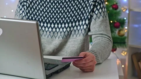 A man makes online purchases on Internet, orders delivery, Christmas gifts for Stock Footage 220451704