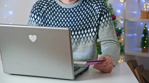 A man makes online purchases on Internet, orders delivery, Christmas gifts for Stock Footage 221601916