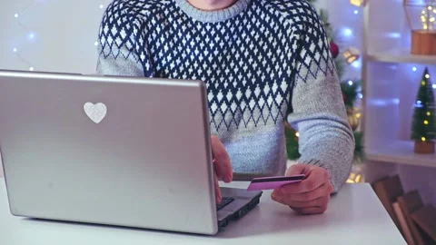 A man makes online purchases on Internet, orders delivery, Christmas gifts for Stock Footage 221867977