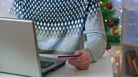 A man makes online purchases on Internet, orders delivery, Christmas gifts for Stock Footage 222432288