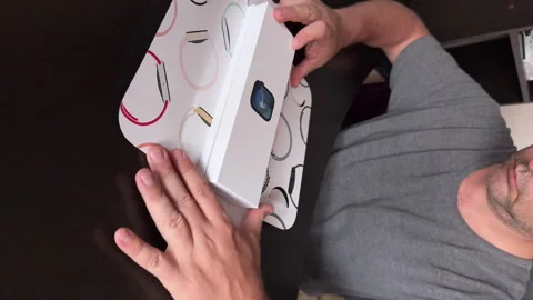The man makes the open smart watch of the Apple Watch Series 9. Outdoing the box Stock Footage 279741805
