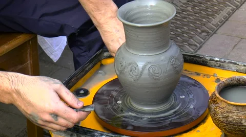 Man makes patterns on the clay pot Stock Footage 68288025