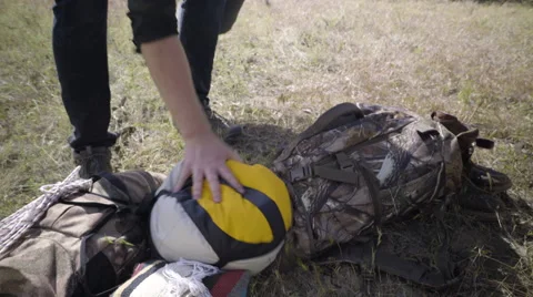Man Makes A Pile Of Camping And Hunting Gear/Equipment Stock Footage
