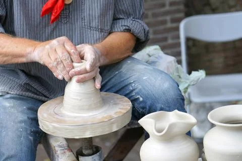 A man makes a pitcher of clay Stock Photos