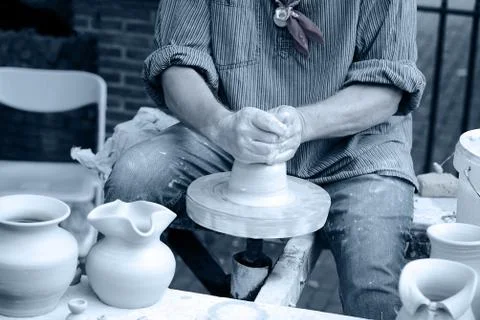 A man makes a pitcher of clay Stock Photos