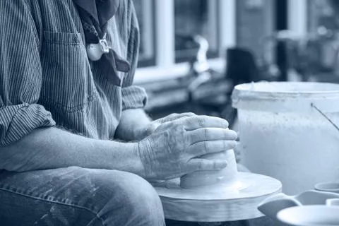 A man makes a pitcher of clay Stock Photos