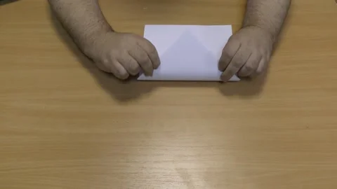 Man makes a plane out of paper Stock Footage 145683801