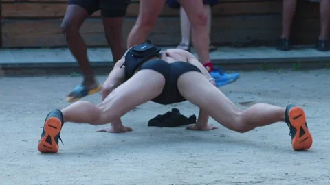 Man makes professional dance movement booty while standing on hands on ground. Stock Footage 138108507