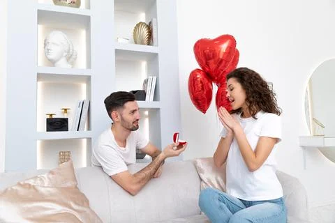 Man makes a proposal with the engagement ring at the Valentines day celebration Stock Photos