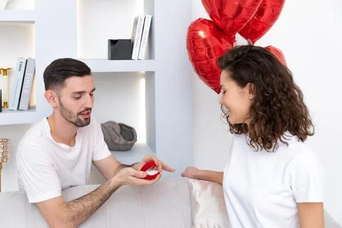 Man makes a proposal with the engagement ring at the Valentines day celebration Stock Photos