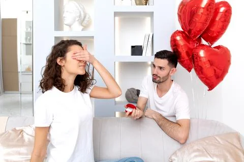 Man makes a proposal with the engagement ring at the Valentines day celebration Stock Photos