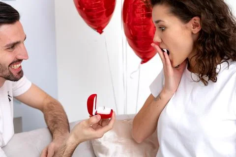 Man makes a proposal with the engagement ring at the Valentines day celebration Stock Photos