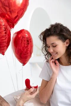 Man makes a proposal with the engagement ring at the Valentines day celebration Stock Photos