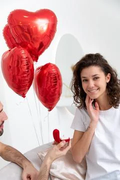 Man makes a proposal with the engagement ring at the Valentines day celebration Stock Photos