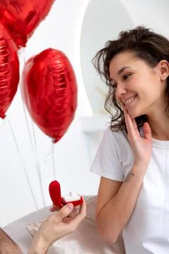 Man makes a proposal with the engagement ring at the Valentines day celebration Stock Photos