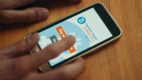 A man makes a purchase on the Internet using bitcoins Stock Footage 106670710