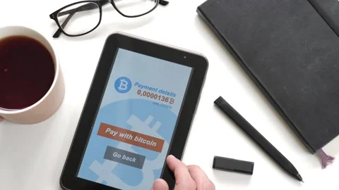 A man makes a purchase on the Internet using bitcoins Stock Footage 106719400