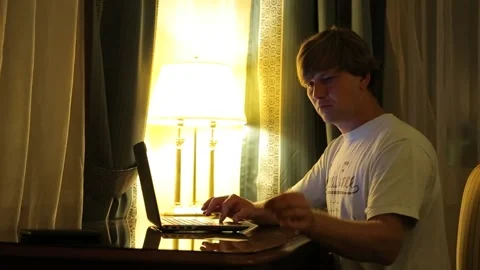 Man makes purchases over Internet on a computer and pays by credit card at home Stock-Footage 97084384