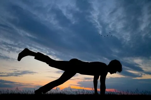 Man makes push-ups on his arms at sunset Stock Illustration