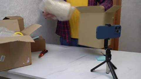 An man makes a return of the product by recording the packaging on his Stock Footage 305027118
