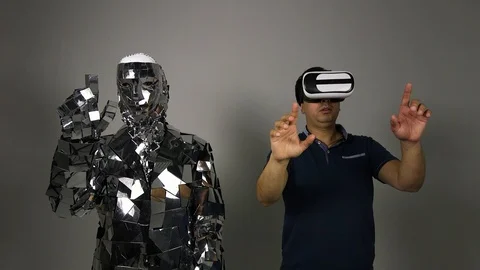 A man makes a robot copy his movements. Stock Footage 92946400