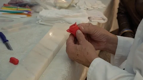 A man makes a rose out of marzipan Stock Footage 126369767