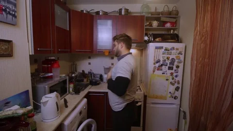 Man makes a sandwich in a dirty kitchen Stock Footage 83137258
