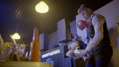 Man makes a show with shaker close-up Stock Footage 76554393