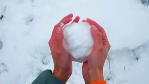 A man makes a snowball with his bare hands and throws it. Stock Footage 221459502