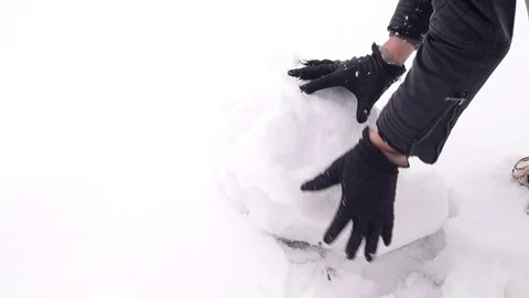 Man makes a snowman Stock Footage