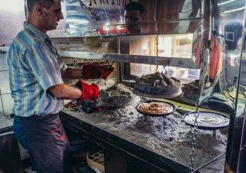 Man makes so called rolled burek in small restaurant in Sarajevo Stock Photos