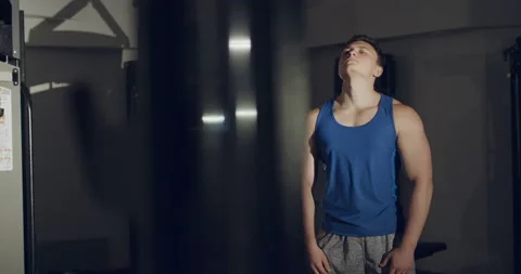 A man makes stretching the neck and circular moves of the head in gym Stock Footage 147101344