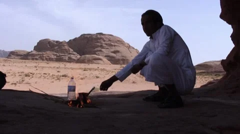 Man makes tea in desert Stock Footage 8724061
