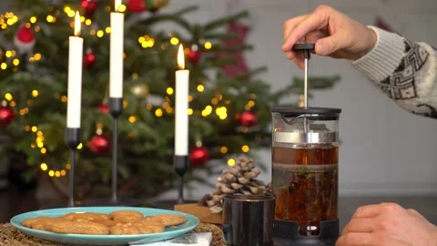 A man makes tea in front of a Christmas tree Stock Footage 167325092