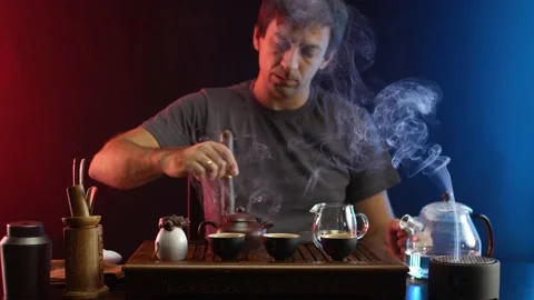 A man makes tea at a tea table with appliances according to the traditional Stock Footage 162431536