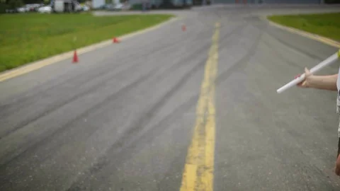 Man makes three swing with a yellow flag and race car breaks off from the start Stock Footage 129924481