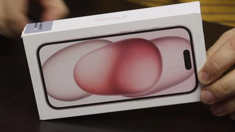 A man makes the unpacking of a modern smartphone. Box with iPhone 15. Close.. Stock Footage 277546532
