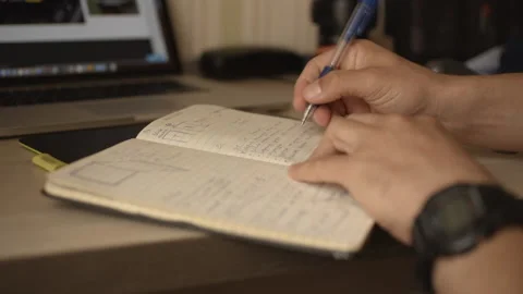 Man makes working entry in his diary Stock Footage 220076379